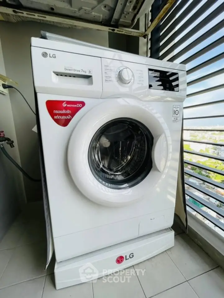 Modern washing machine on a balcony with city view, perfect for urban living convenience.