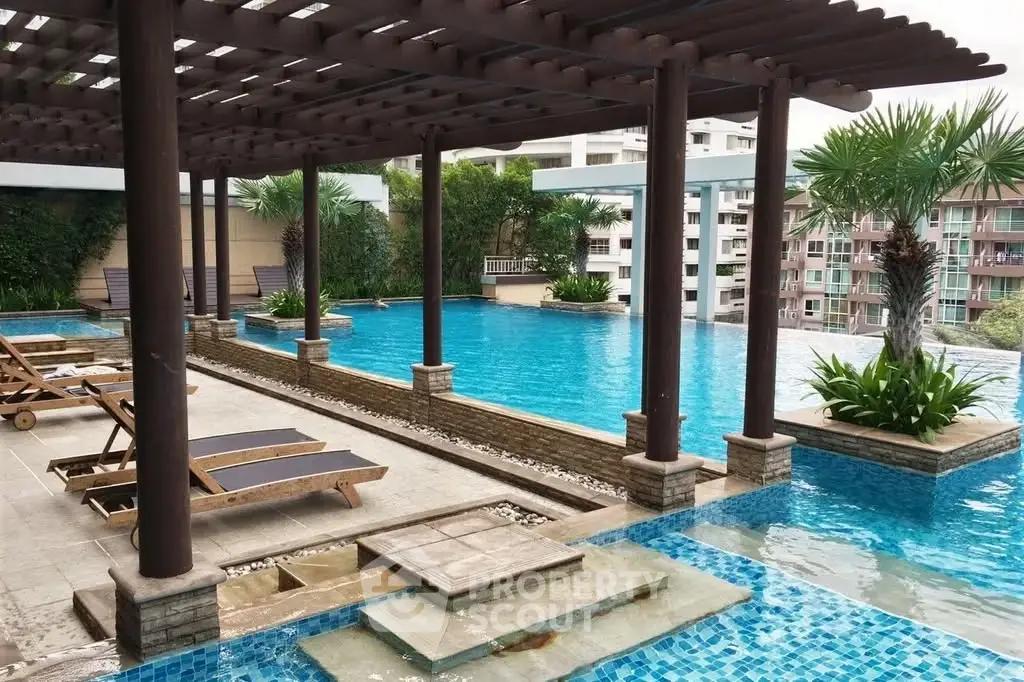 Luxurious rooftop pool with modern design and lush greenery in a high-end residential complex.