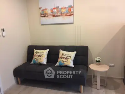 Cozy living room with stylish sofa and vibrant wall art, perfect for relaxation.