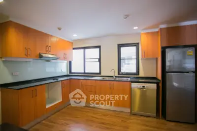 Modern kitchen with wooden cabinets and stainless steel appliances