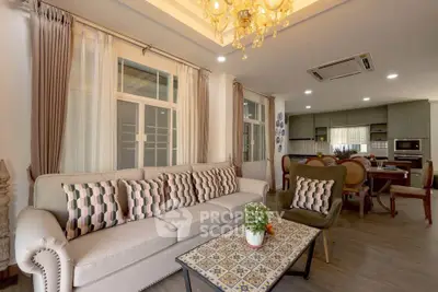 Luxurious living room with elegant decor and open kitchen layout, perfect for modern living.