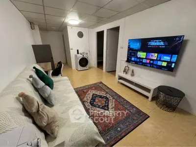 Cozy living room with modern TV setup and comfortable seating
