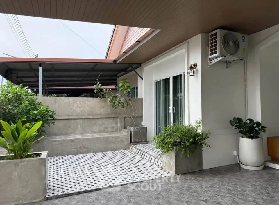 Charming modern home exterior with stylish patio and lush greenery