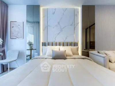 Luxurious modern bedroom with elegant marble accent wall and plush bedding.