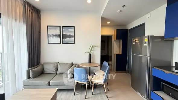 Modern living room with cozy sofa and dining area in open layout apartment