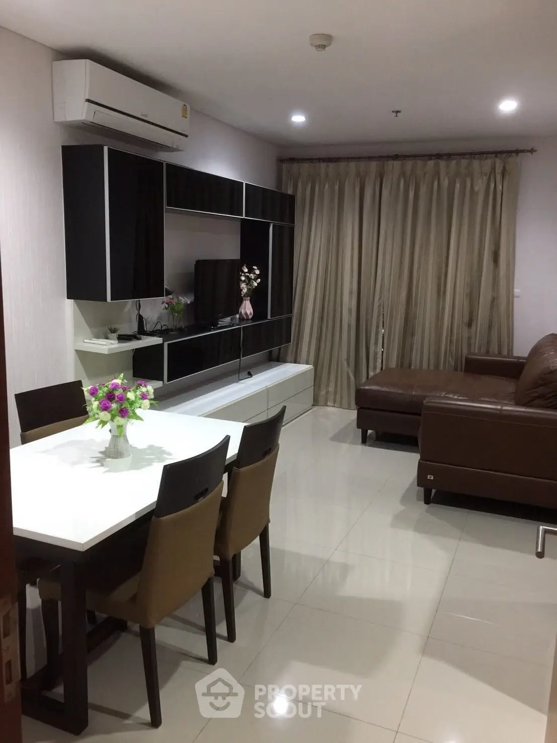 Modern living room with sleek furniture and elegant decor in a stylish apartment.