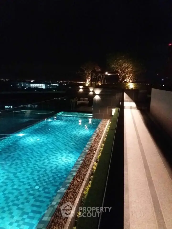 Luxurious rooftop pool with stunning night view, perfect for relaxation and entertainment.