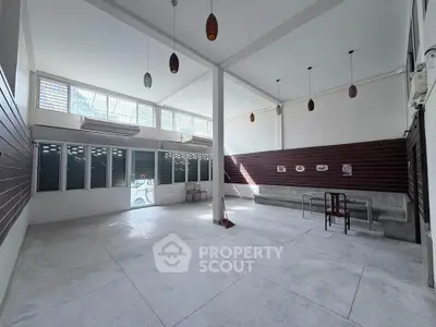 Spacious open-plan interior with high ceilings and modern lighting, perfect for versatile use.