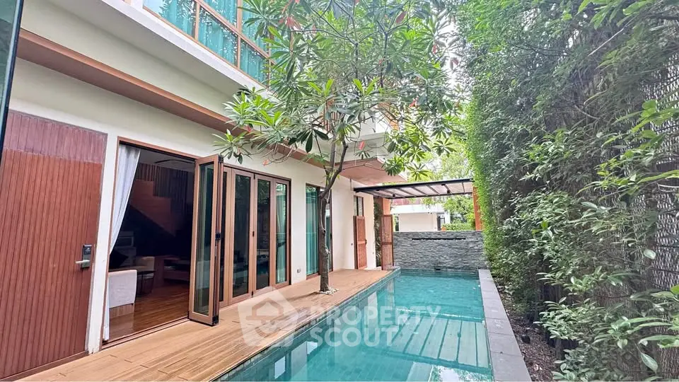 Luxurious modern home with private pool and lush greenery, perfect for relaxation and entertaining.