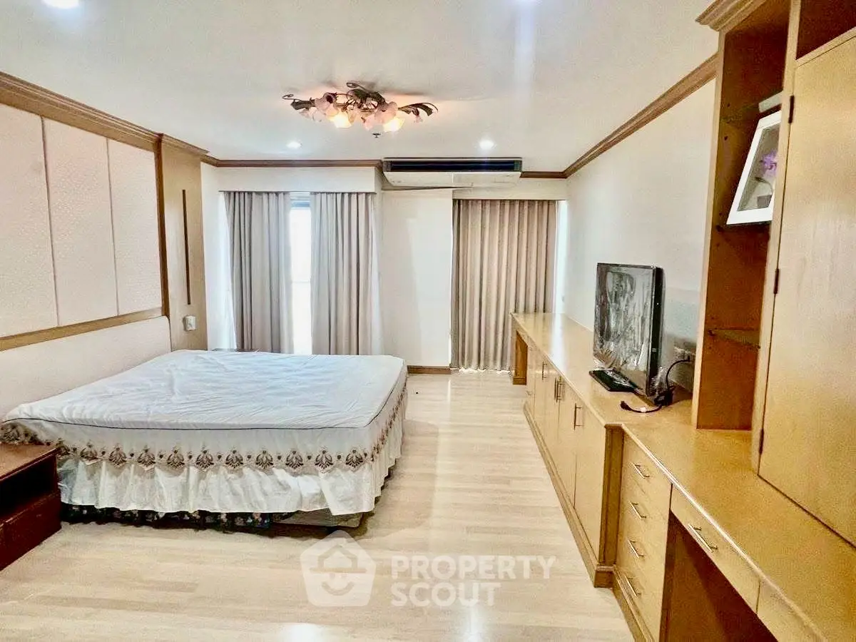 Spacious bedroom with elegant decor and ample natural light