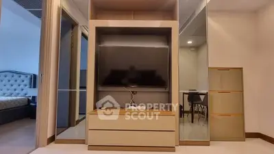 Modern living room with sleek TV unit and mirrored storage