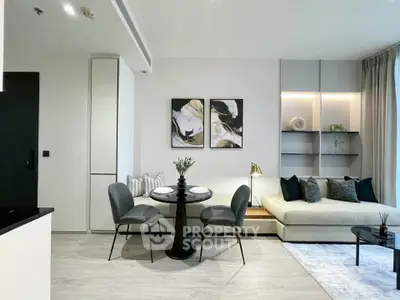Modern living room with stylish decor, featuring a cozy seating area and elegant dining setup.