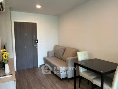 Cozy living room with modern furniture and dining area, perfect for relaxation and entertaining.