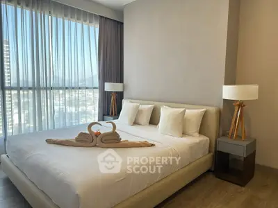 Luxurious bedroom with elegant decor and city view, featuring a cozy bed and stylish lamps.