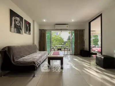 Spacious living room with modern decor and balcony view