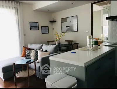 Modern open-layout living room with stylish decor and cozy seating area.