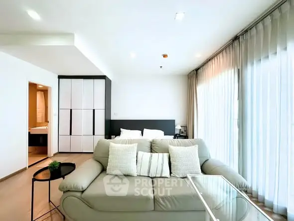 Modern living room with stylish sofa and natural light in a contemporary apartment.