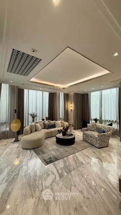 Luxurious living room with elegant marble flooring and stylish furniture, perfect for modern living.