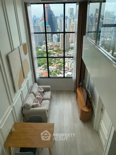 Stunning high-rise living room with floor-to-ceiling windows offering breathtaking city views.
