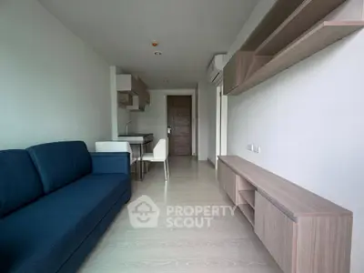 Modern living room with sleek furniture and open kitchen layout