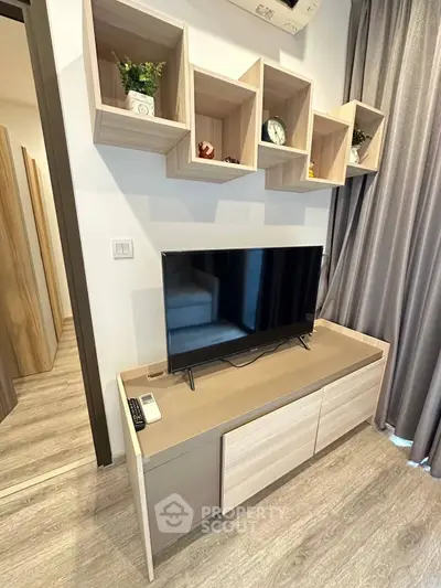 Modern living room with stylish TV stand and wall shelves, perfect for contemporary urban living.