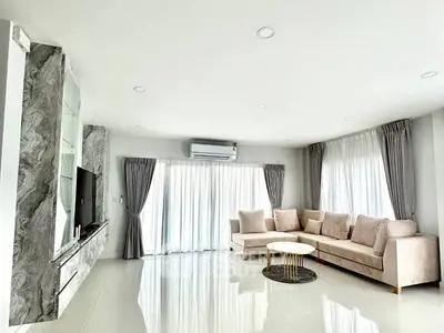 Spacious modern living room with elegant marble accents and plush seating