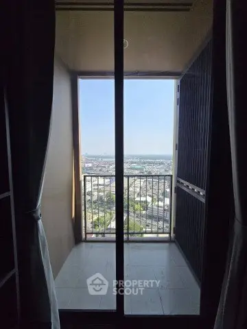 Stunning balcony view from high-rise apartment with expansive cityscape.