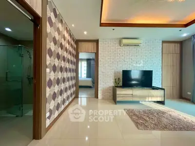 Spacious living room with modern decor and TV unit, featuring stylish wallpaper and natural light.