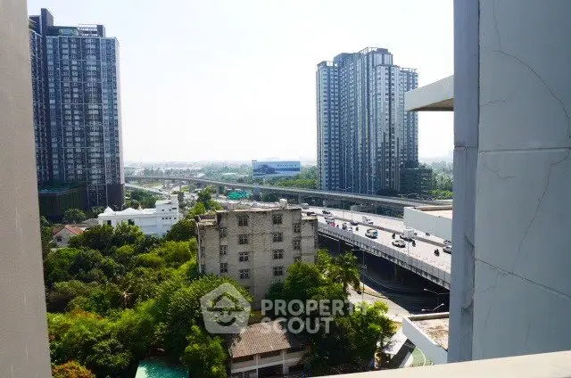 Stunning urban view from high-rise balcony overlooking cityscape and highways.