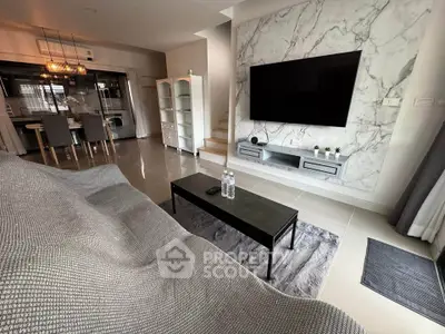 Modern living room with marble accent wall and sleek TV setup