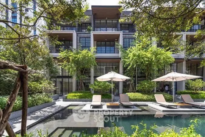 Luxurious modern apartment with poolside view and lush greenery, perfect for relaxation and leisure.