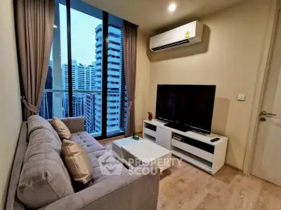 Modern living room with city view, featuring sleek furniture and large windows.