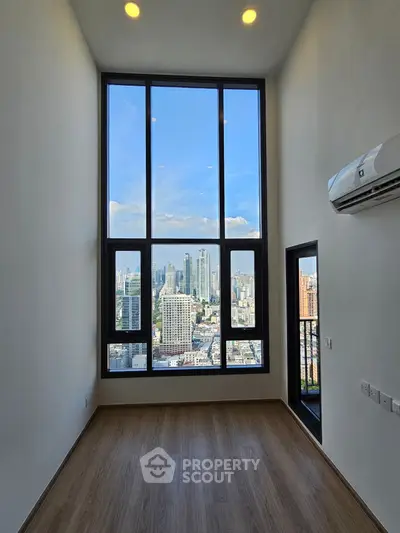 Stunning high-rise apartment with floor-to-ceiling windows offering breathtaking city views.