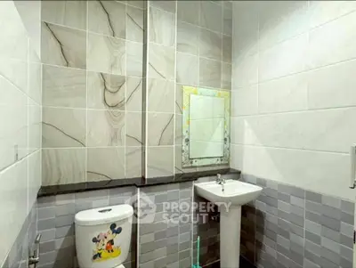 Charming bathroom with unique tile design and pedestal sink