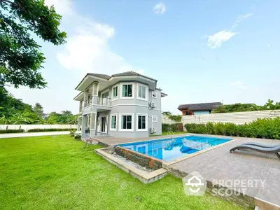 Stunning modern two-story house with pool and lush garden, perfect for luxury living.