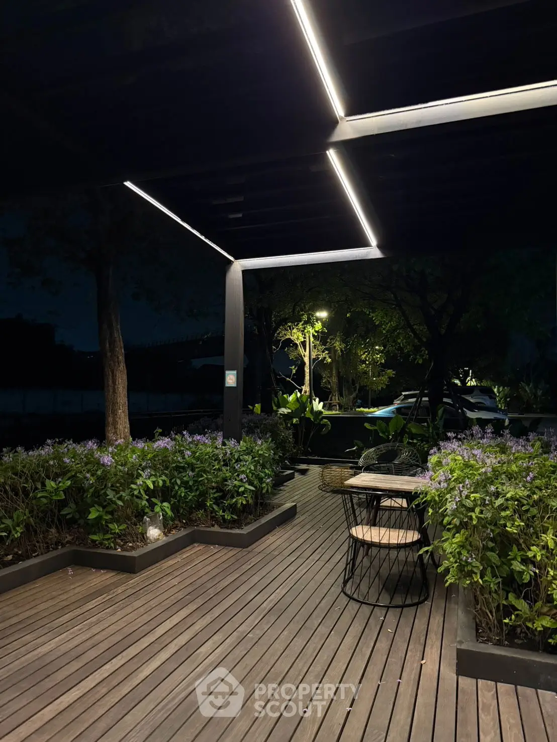 Modern rooftop garden with sleek lighting and lush greenery