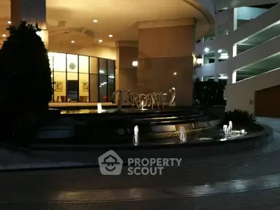 Elegant entrance with modern water feature and ambient lighting at luxury property