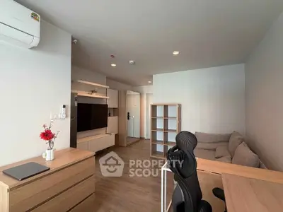 Modern living room with cozy sofa, TV unit, and workspace in stylish apartment.