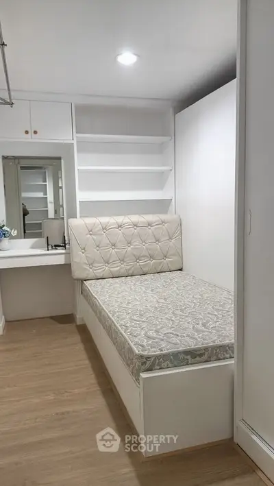 Compact bedroom with built-in storage and cozy single bed
