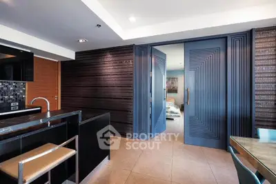 Modern open-layout kitchen with sleek black countertops and stylish dining area