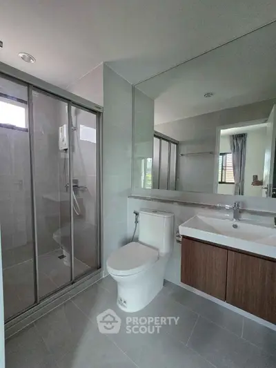 Modern bathroom with glass shower and sleek fixtures