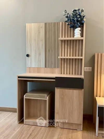 Modern wooden study desk with shelves and decorative vase in stylish interior.