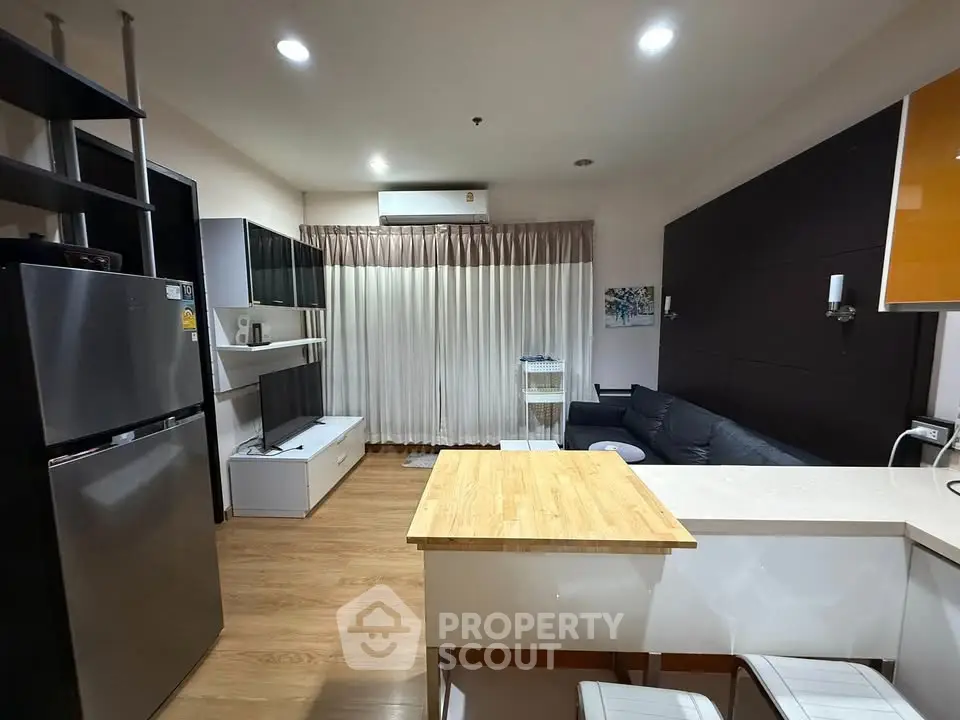 Modern living room with open kitchen and stylish decor in a cozy apartment.