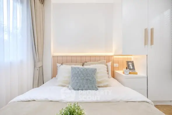 Cozy and modern bedroom with elegant decor and natural light.