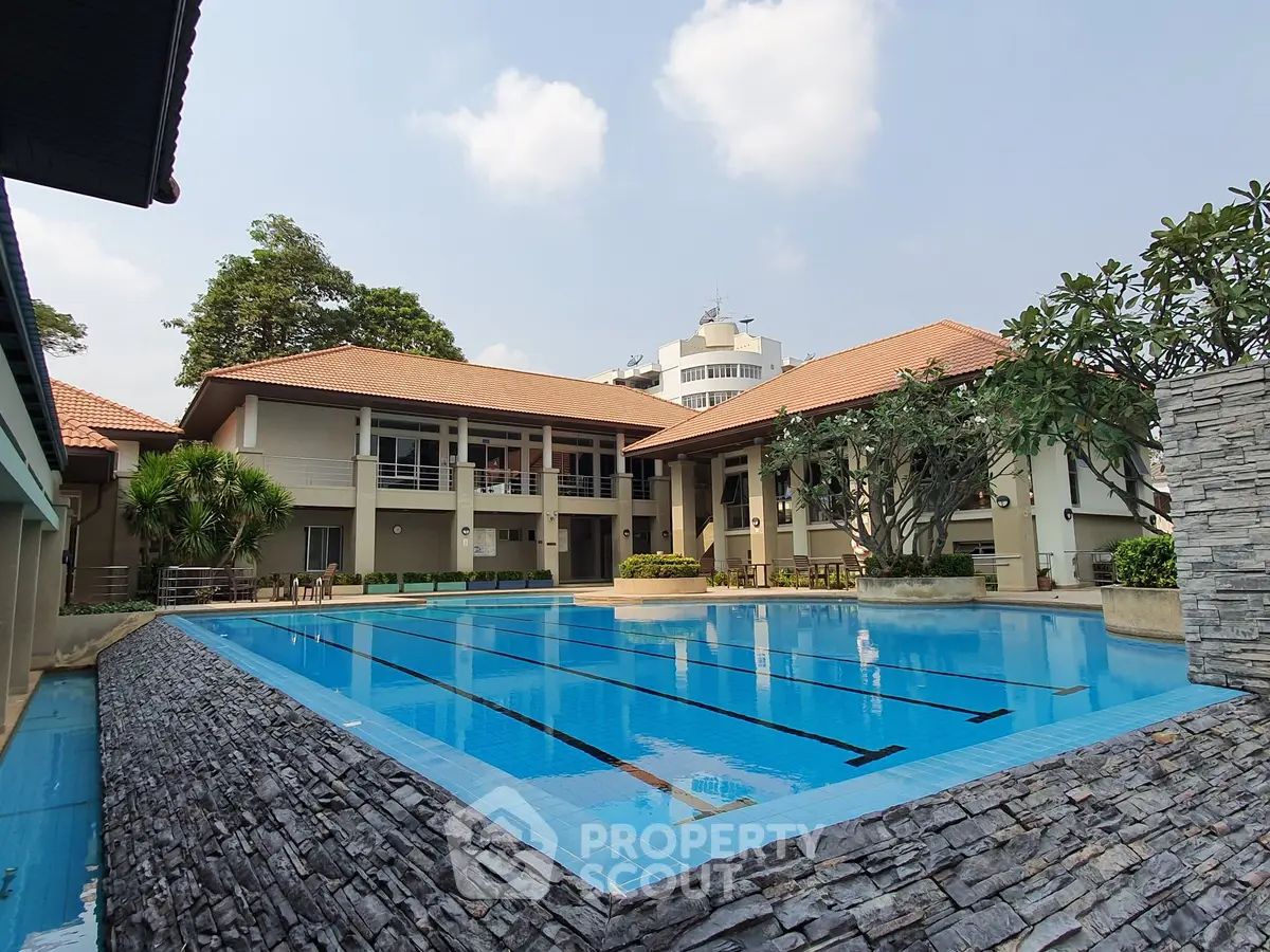 Luxurious residential complex with a stunning outdoor swimming pool and modern architecture.