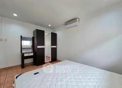 Spacious bedroom with modern wardrobe and air conditioning, perfect for comfort and relaxation.