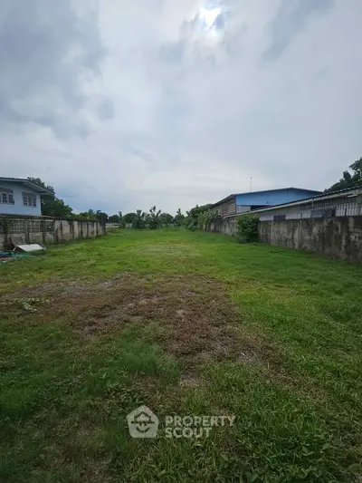 Spacious vacant land plot with lush greenery, ideal for residential development or investment opportunity.