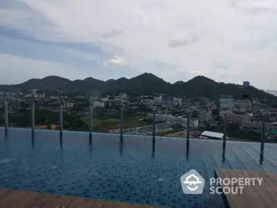 Stunning rooftop pool with panoramic mountain views in a luxury high-rise building.