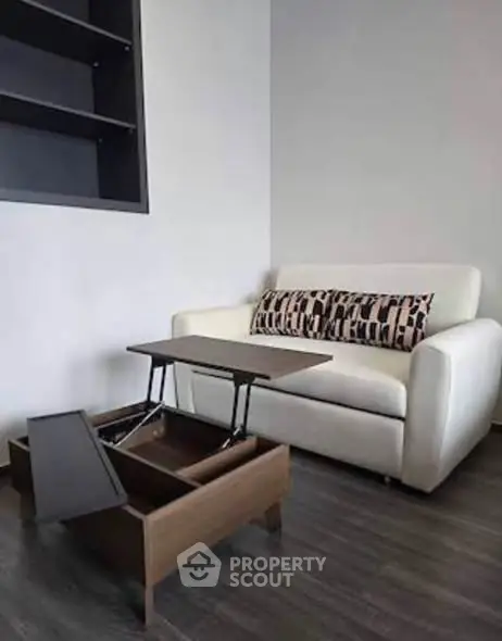 Modern living room with stylish sofa and multifunctional coffee table in a cozy apartment.