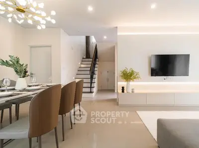 Modern living room with elegant dining area and stylish staircase